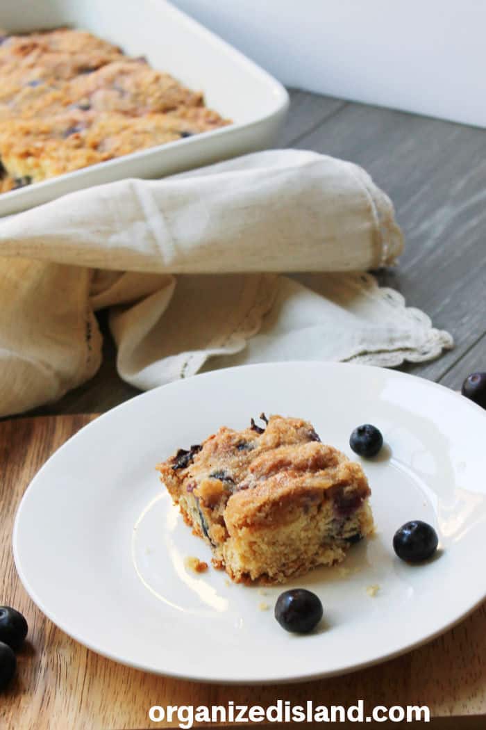 Blueberry Coffee Cake on plate with blueberries.