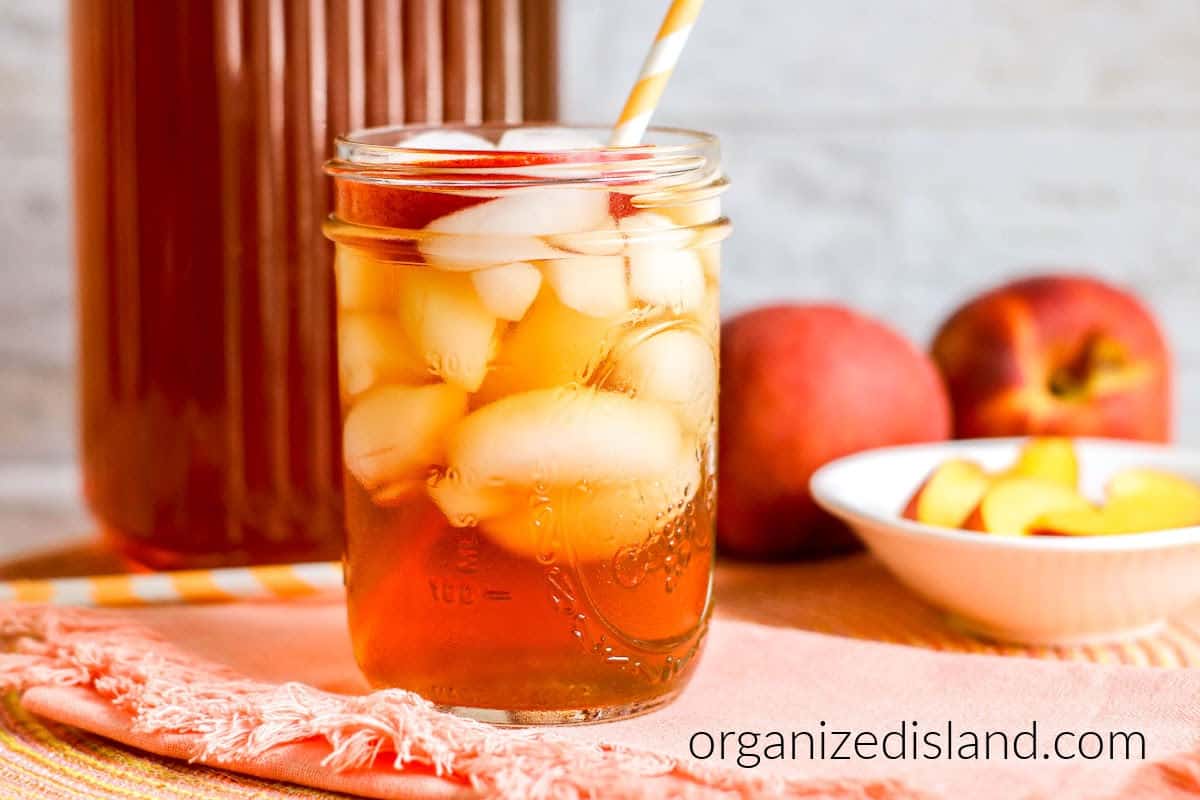 Peach Iced tea made from peach syrup in glass with ice.