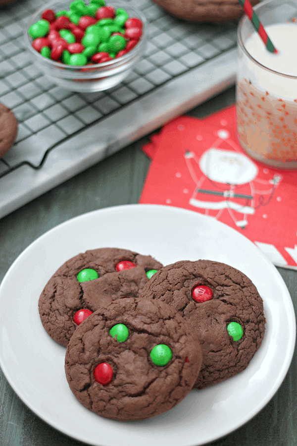 Hot chocolate cake mix cookies topped with M&Ms on a white plate.