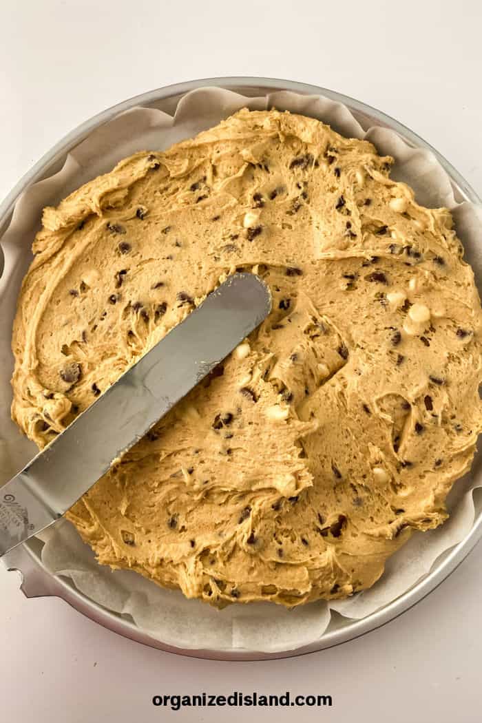 cookie dough spread in round cake pan