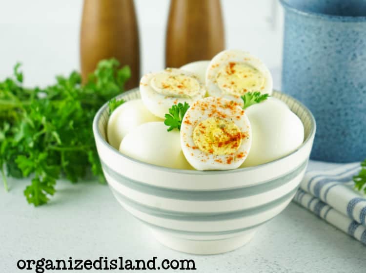 Air fryer hard boiled eggs in bowl with seasoning.