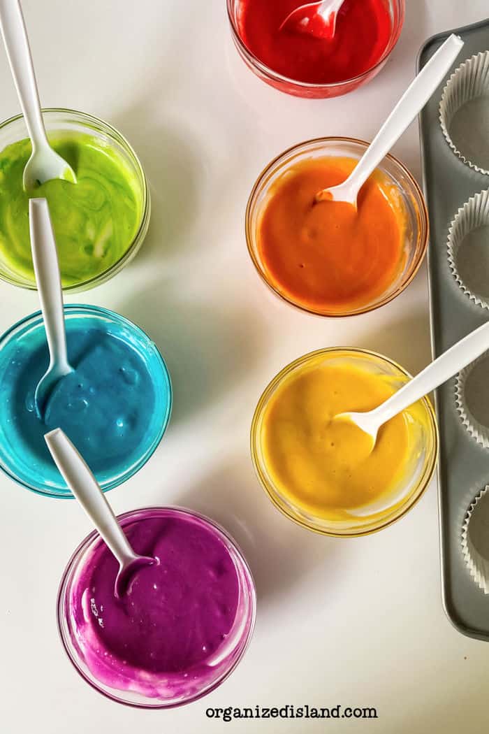 Making Rainbow Cake Batter - six colors of batter in separate bowls.