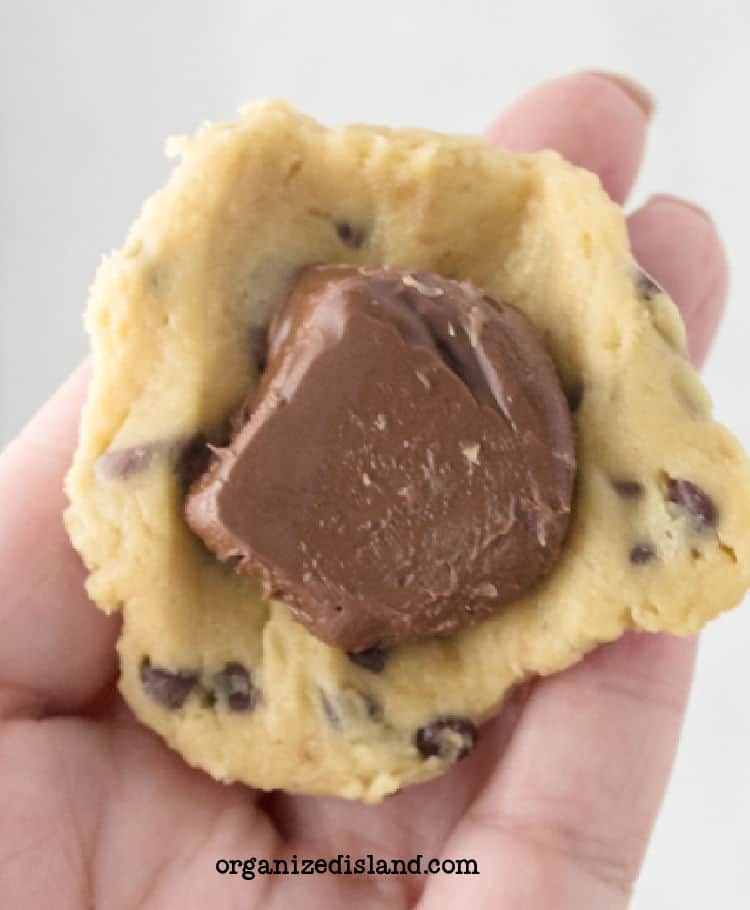 wrapping frozen nutella dollops with cookie dough.