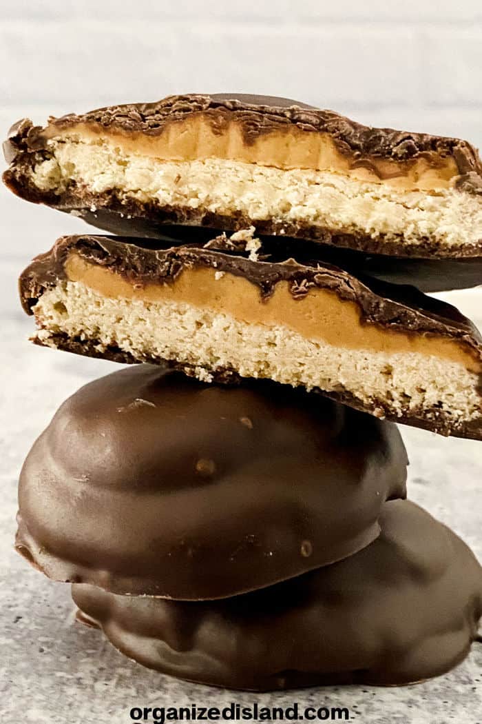 Easy Tagalong Cookies cut in half with shortbread and peanut butter lauers.