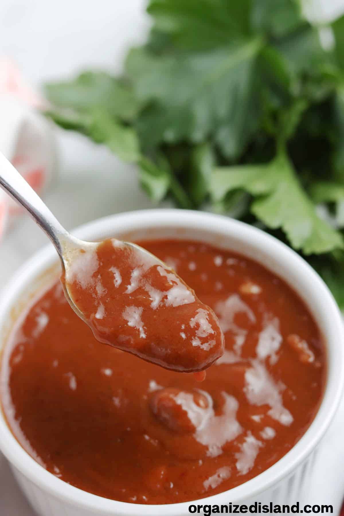 Homemade Hoisin sauce in bowl with sooon.