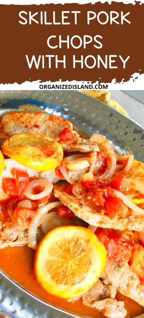 Skillet Pork Chops with Honey on platter with onions and orange slices.