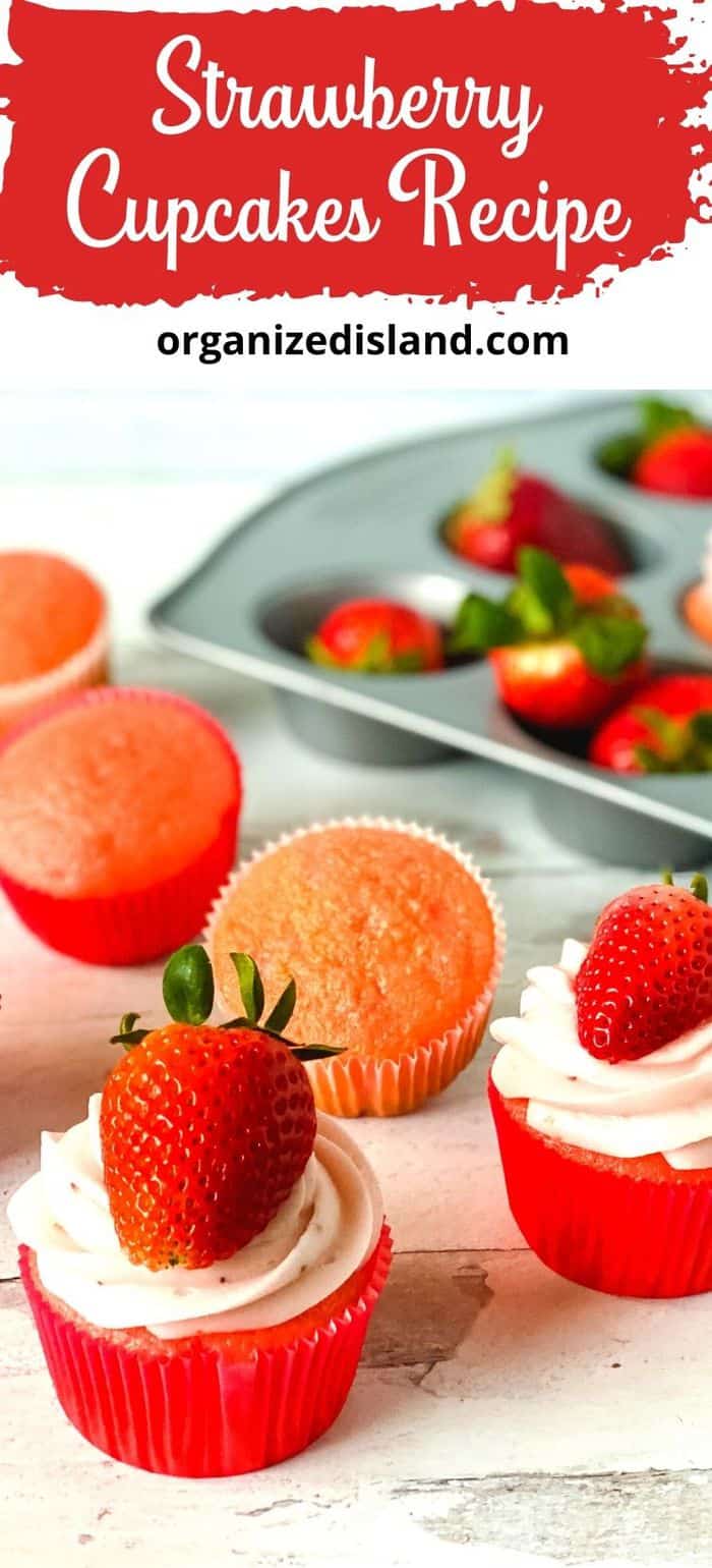 Strawberry cupcakes with frosting and topped with whole strawberries.