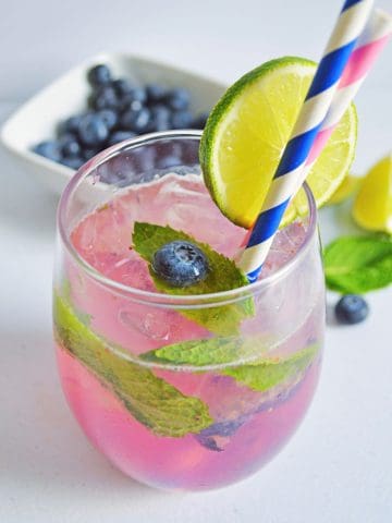 Blueberry Mojito Recipe in glass with lime.
