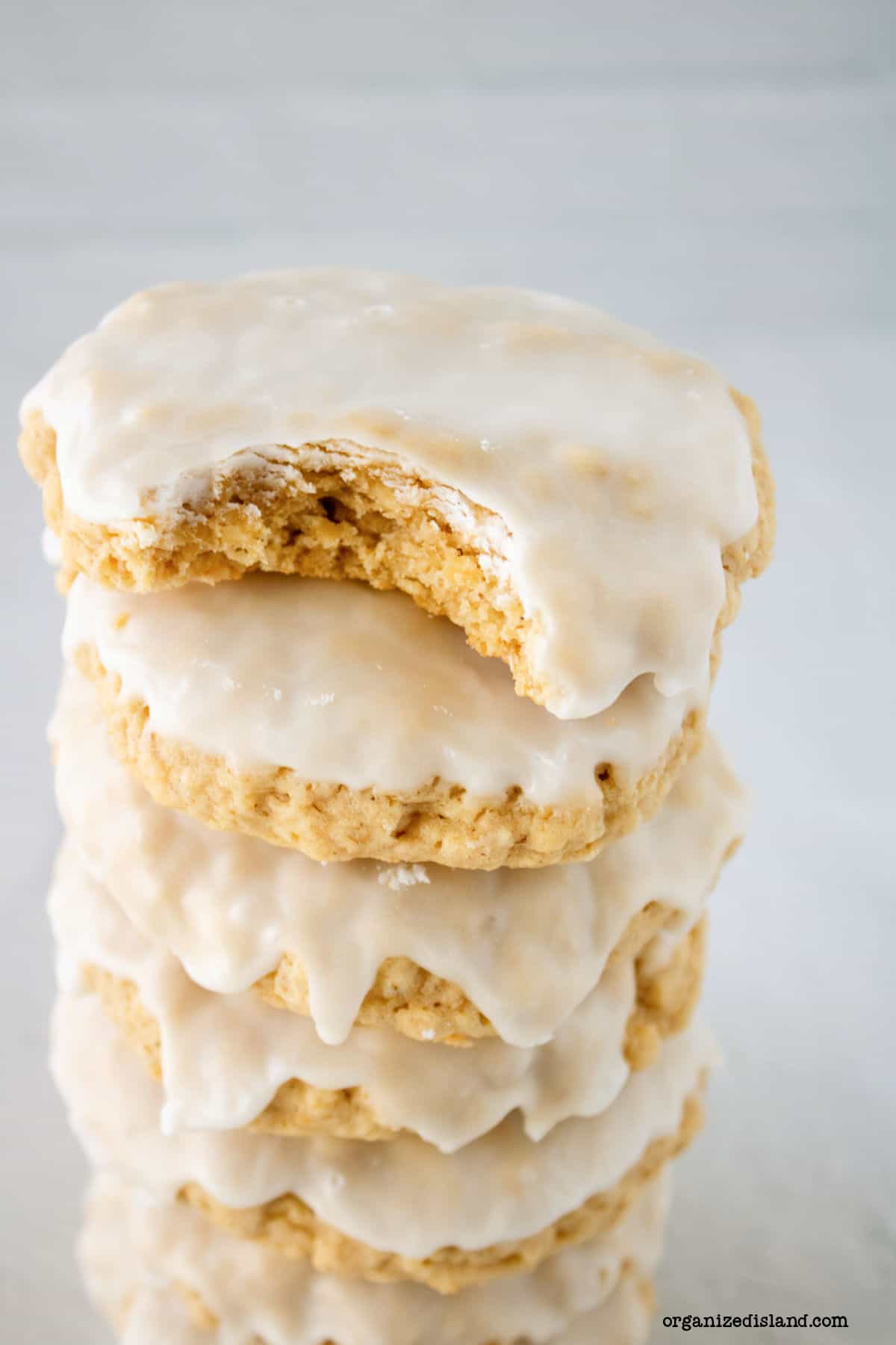 Stacked iced oatmeal cookies.