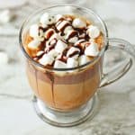 Hoe to make Baileys Hot Chocolate - drink in mug with marshmallows and chocolate sauce.