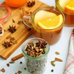 Mulling Spices in a jar next to a glass of cier.