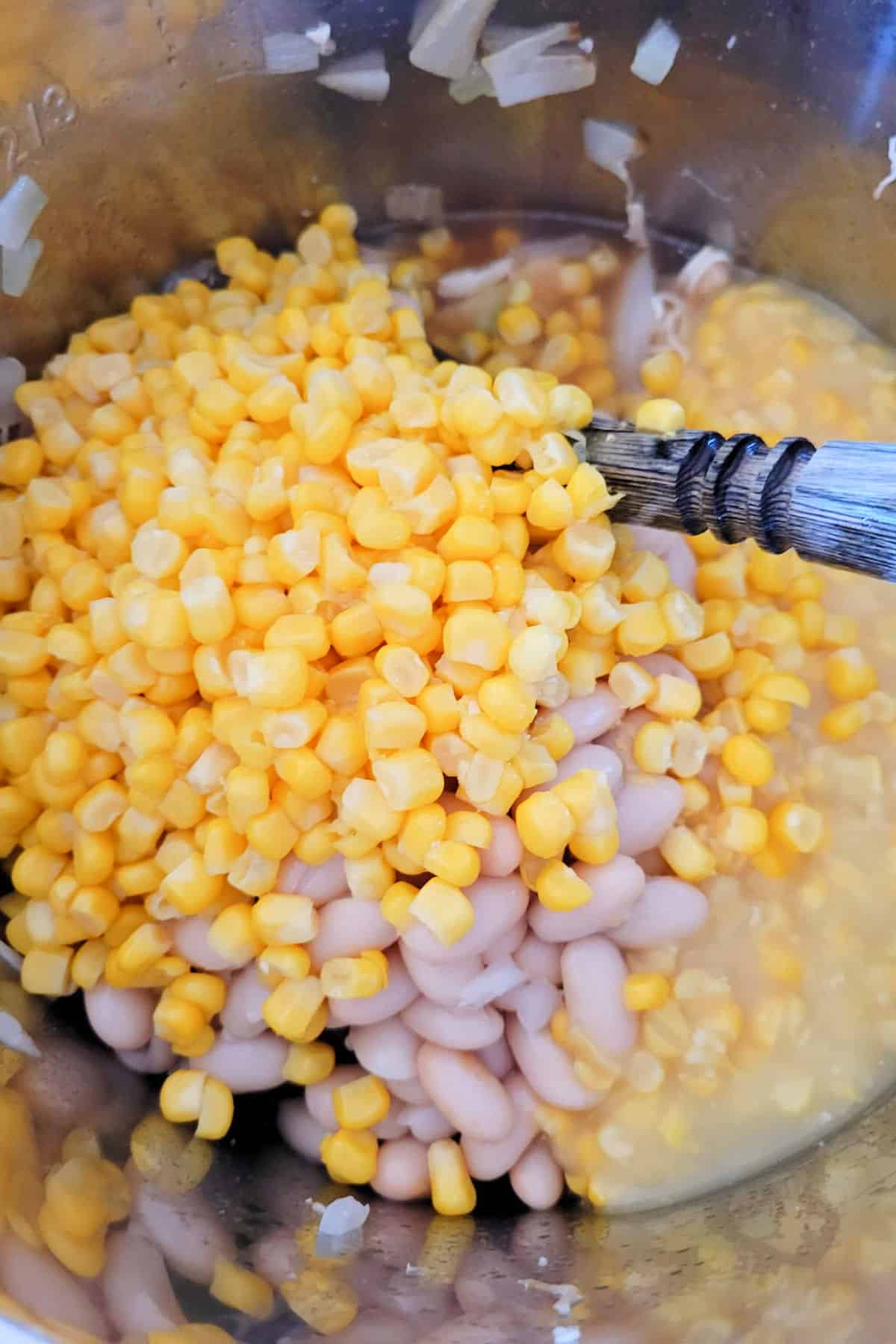 Adding beans and corn to Chick Fil A .chicken soup.