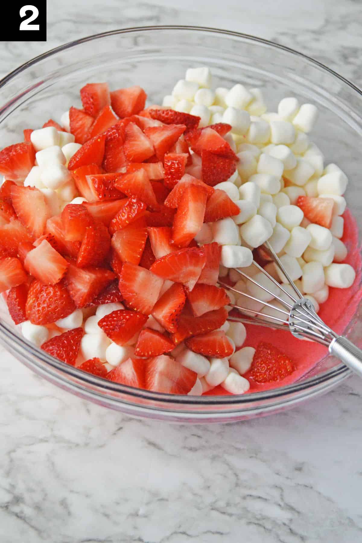 How to make Strawberry Fluff Step 2 adding marshmallows to bowl.