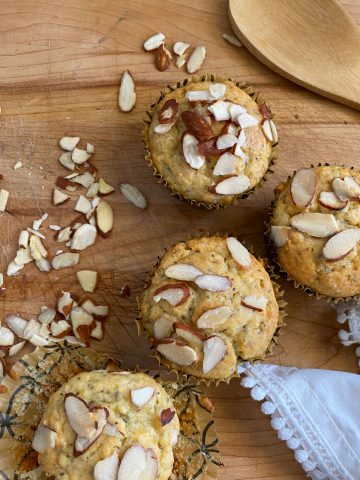 Almond muffins on cutting board.