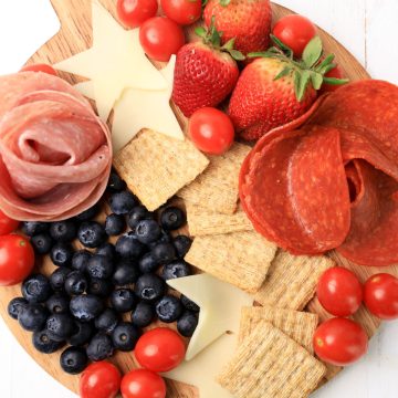 This 4th of July Charcuterie Board i with Red white and blue foods.