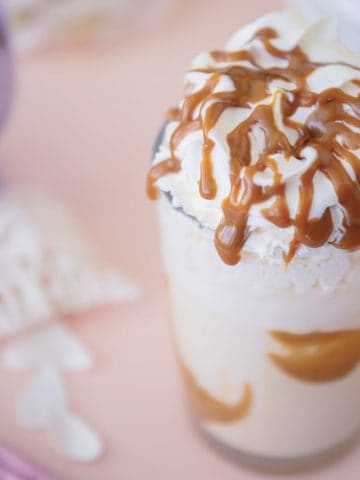 Caramel Milkshake with whipped cream and caramel in glass.