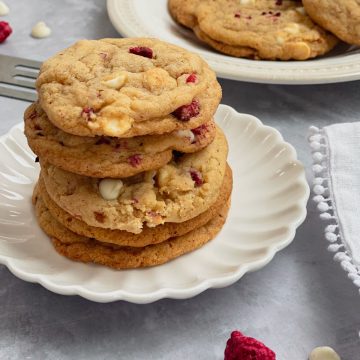 Raspberry Cheesecake Cookies stacked on plate.