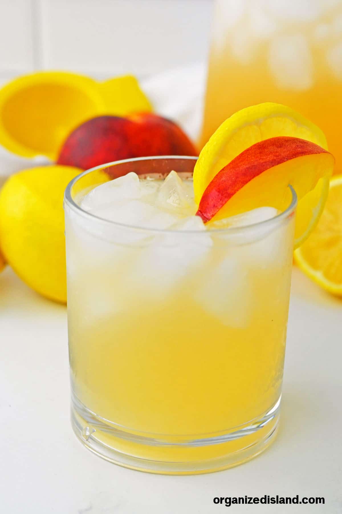 Peach Lemonade in glass with peach slice.