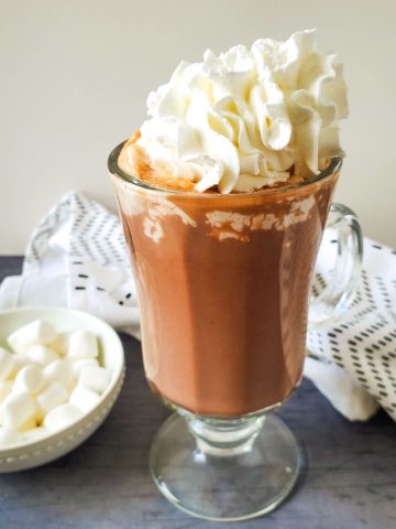 Easy Peanut Butter Hot Chocolate in cup with whipped cream.