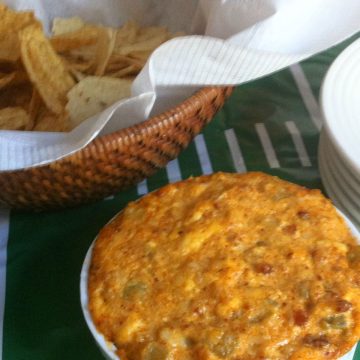 Chorizo with Queso hot dip next to tortilla chops.