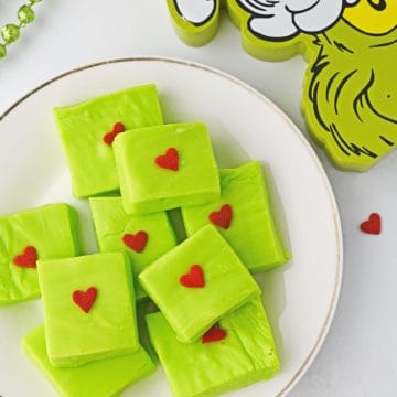 How to make Grinch Fudge step 4 - red hearts on candy squares.