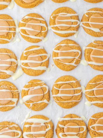 Iced Gingerbread Thumbprint Cookies on cookie sheet.