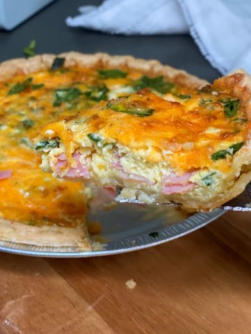 Ham Spinach Quiche with slice pulled out.