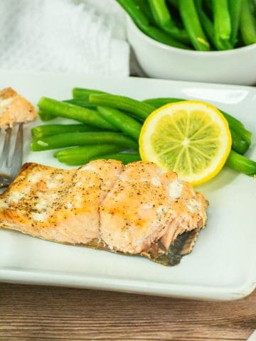 Oven Broil Salmon on plate with lemon.