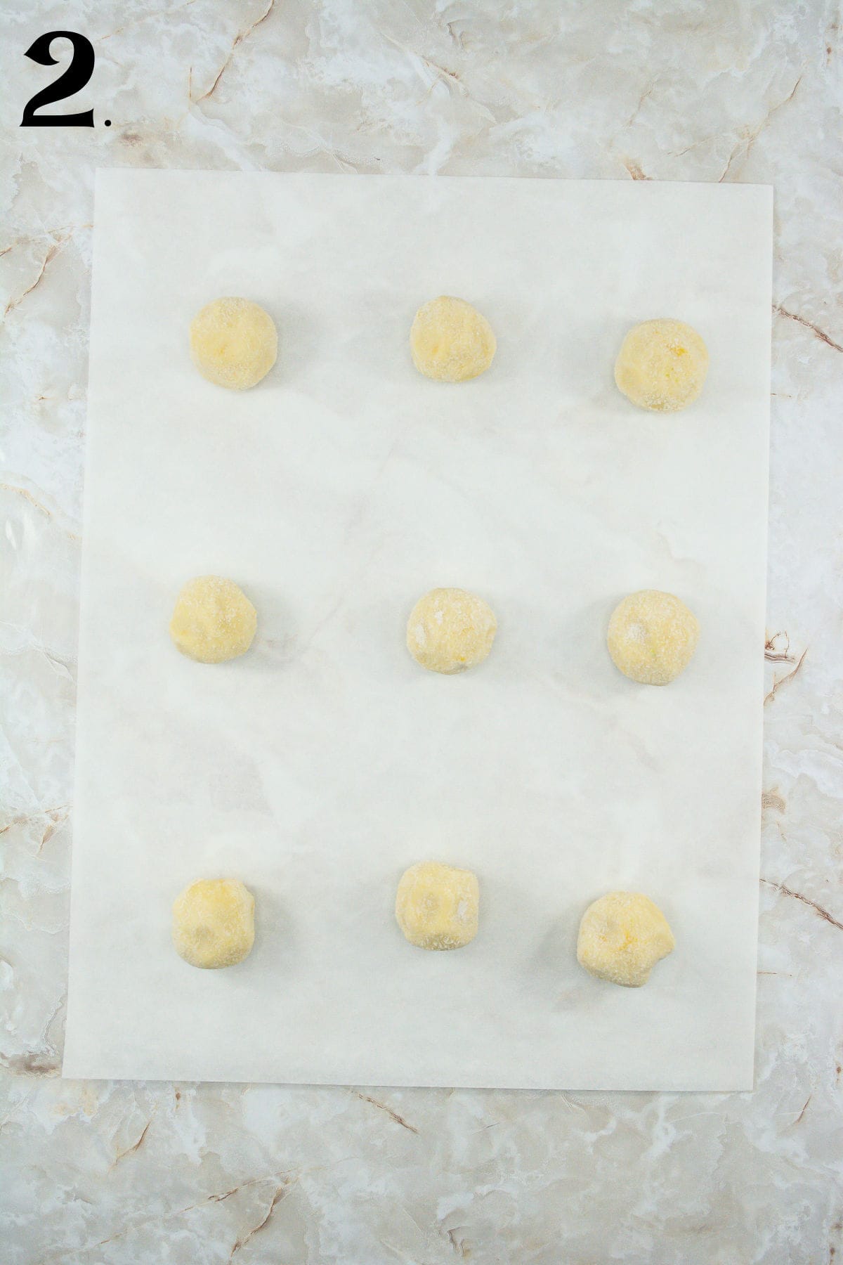 How to Make Lemon Meringue Cookies Step 2 - cookie balls on parchment paper.