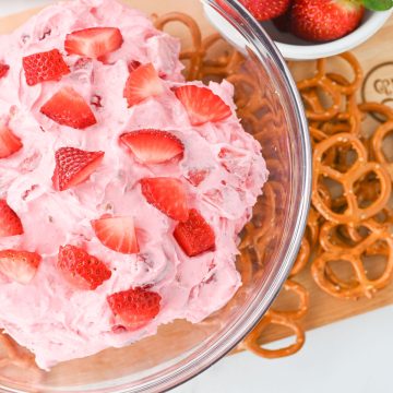 How to make Strawberry Pretzel Dip step 5 with fresh strawberries in bowl.