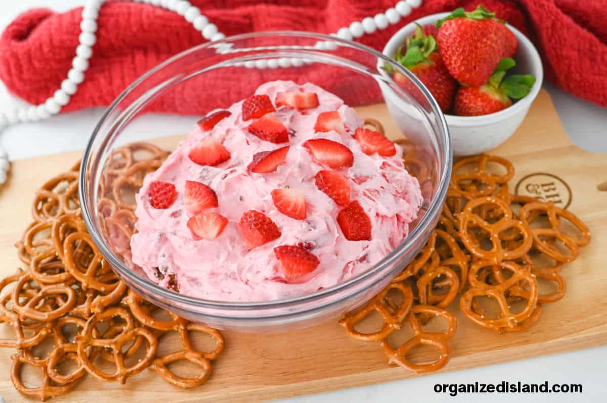 Strawberry Pretzel Dip with pretzels in bowl on board. Landscape