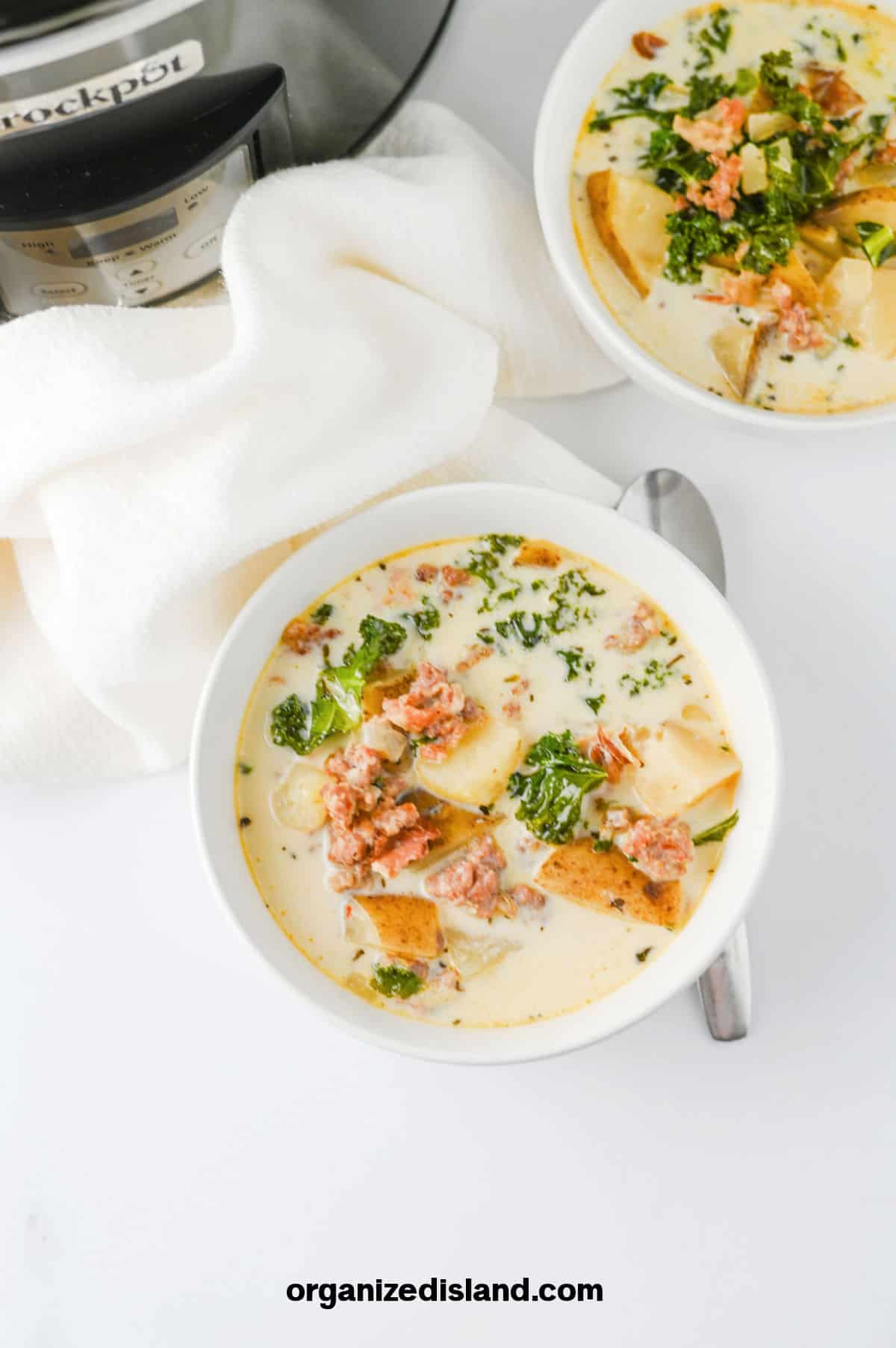 Crock Pot Zuppa Toscana next to slow cooker.
