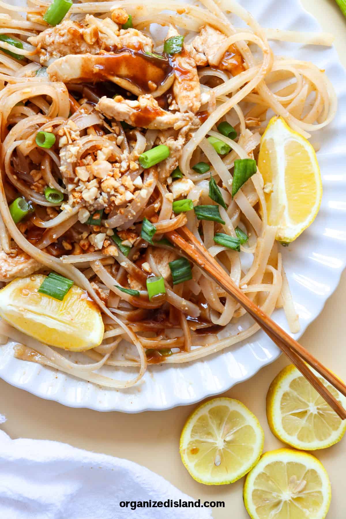 Easy Chicken Pad Thai on white plate with chopsticks.