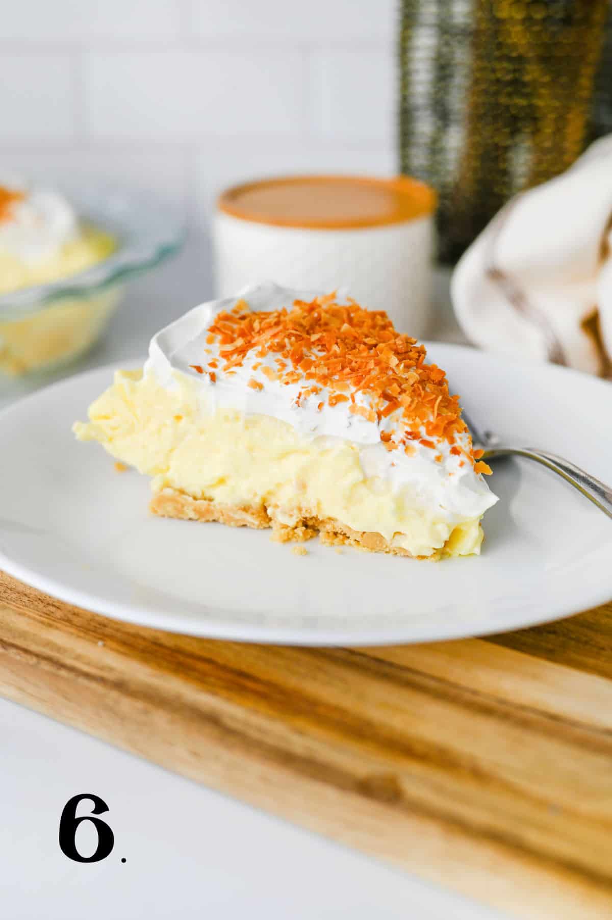 ow to Make Coconut Cream Pie - final step with slice of pie on plate.