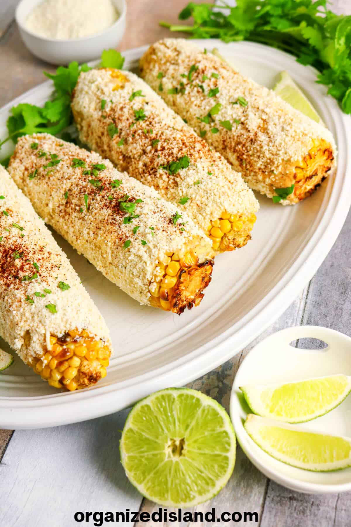 Mexican Street Corn Recipe Easy on plate with limes.