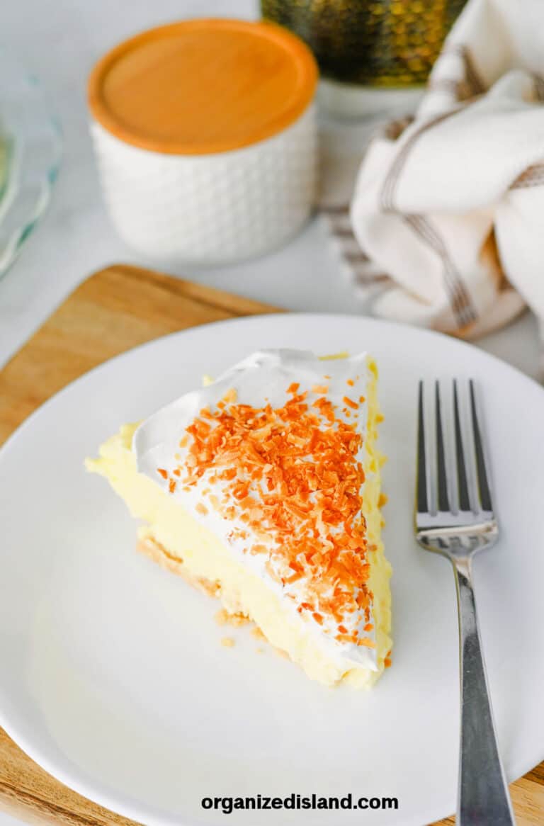 No Bake Coconut Cream Pie on white plate with ofork.