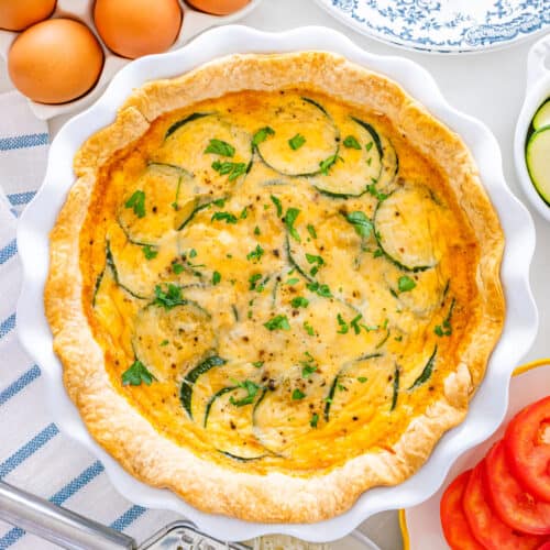Easy Zucchini Quiche on a white pie plate.
