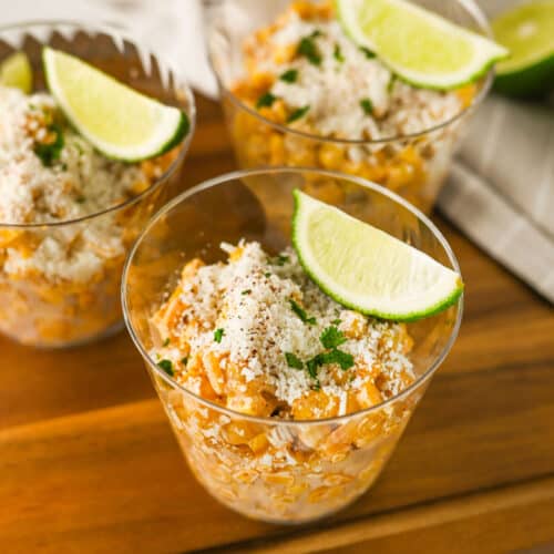 Easy Elotes Cups topped with slices of lime.