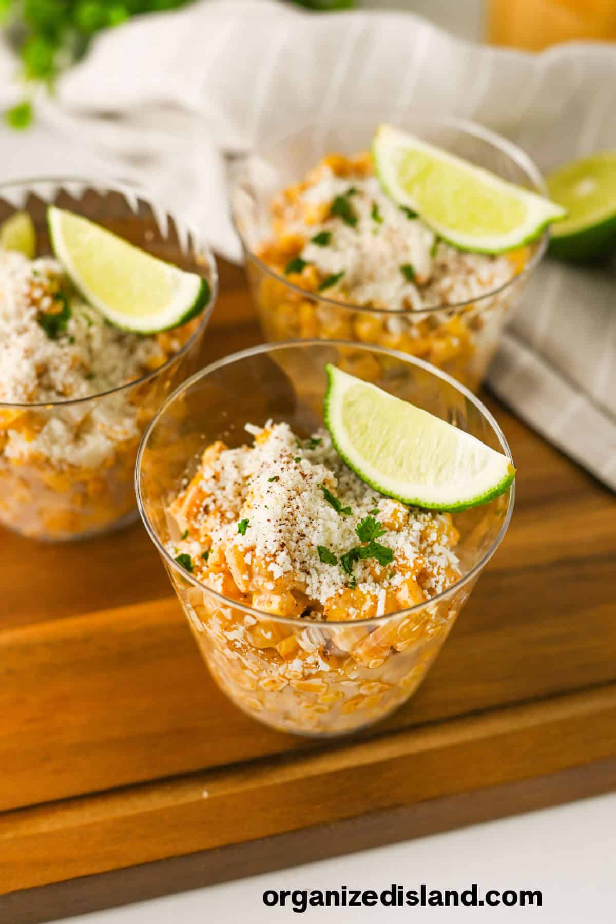 Easy Elotes Cups topped with slices of lime.