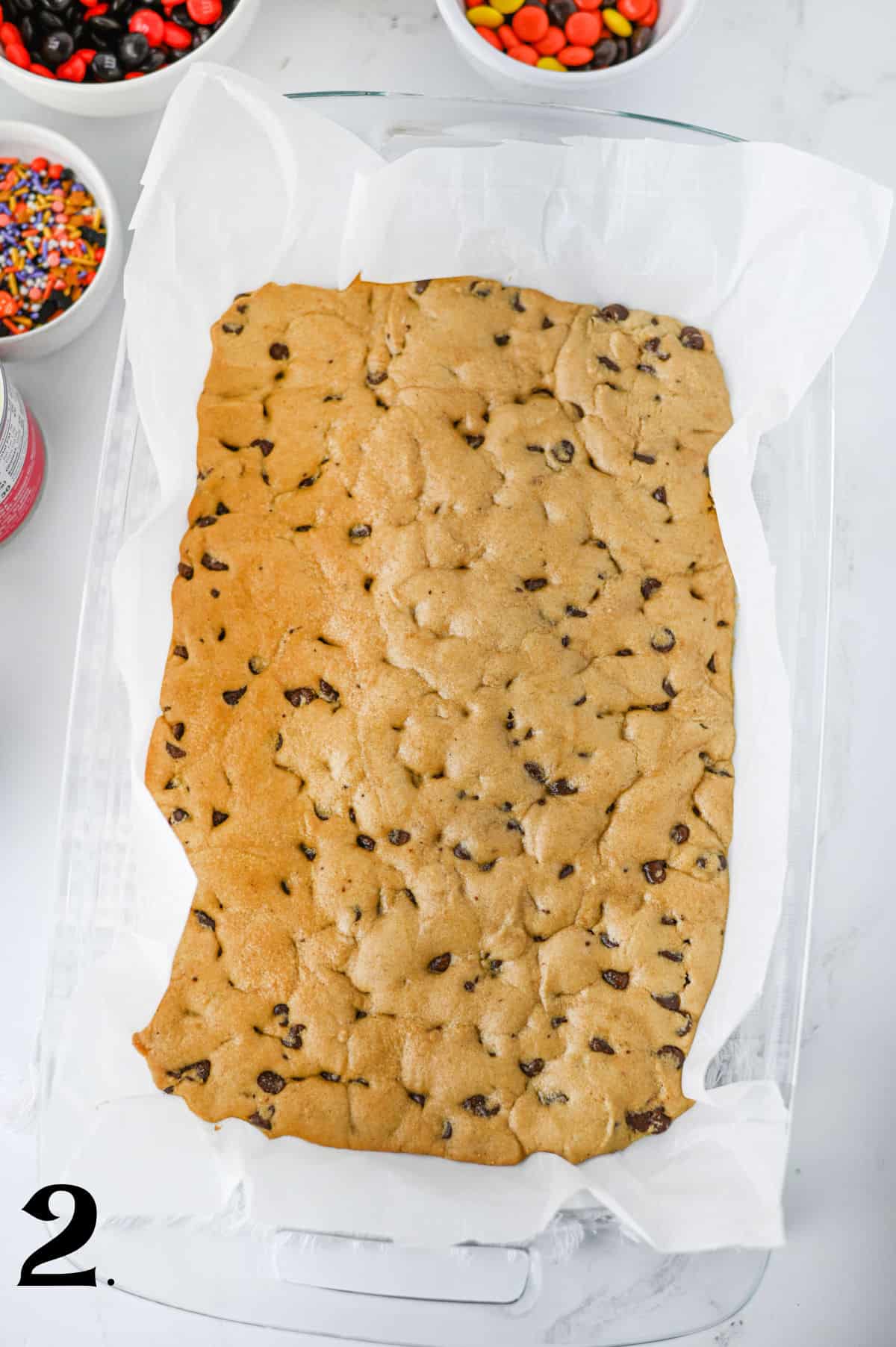 How to Make Halloween Cookie Bars Step 2 - baked cookie dough in pan.