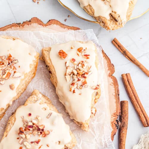 Easy Pecan Maple Scones with cinnamon sticks and nuts on top.