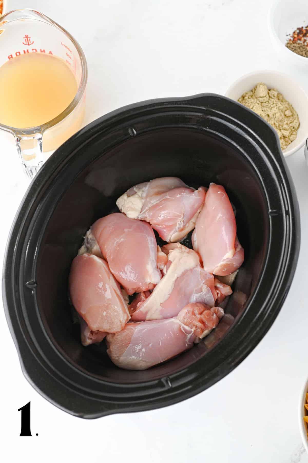 How to Make Crockpot Crack Chicken Pasta Step 1 - adding chicken to crock pot.