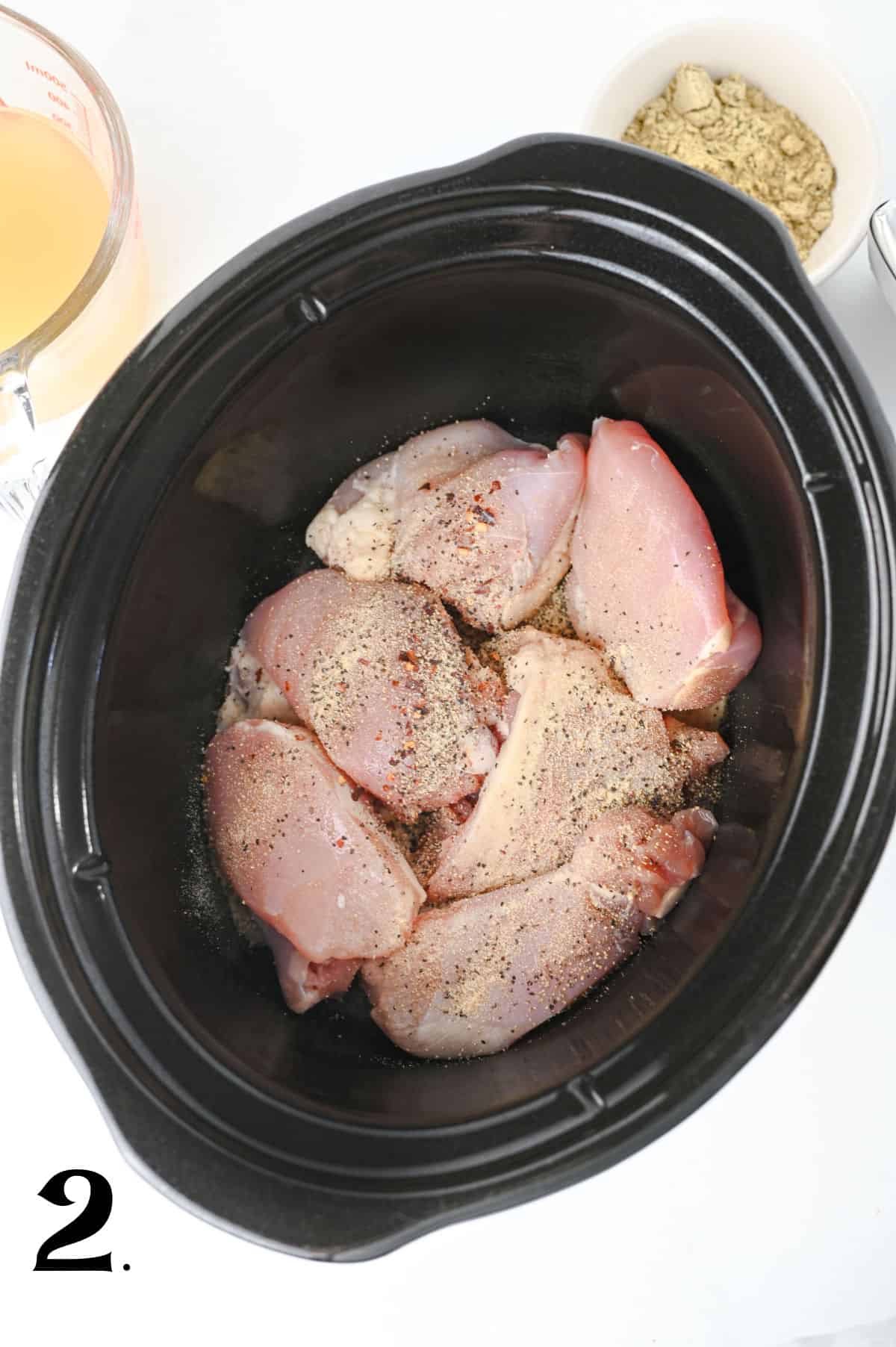 How to Make Crockpot Crack Chicken Pasta Step 2 - adding seasonings to chicken.
