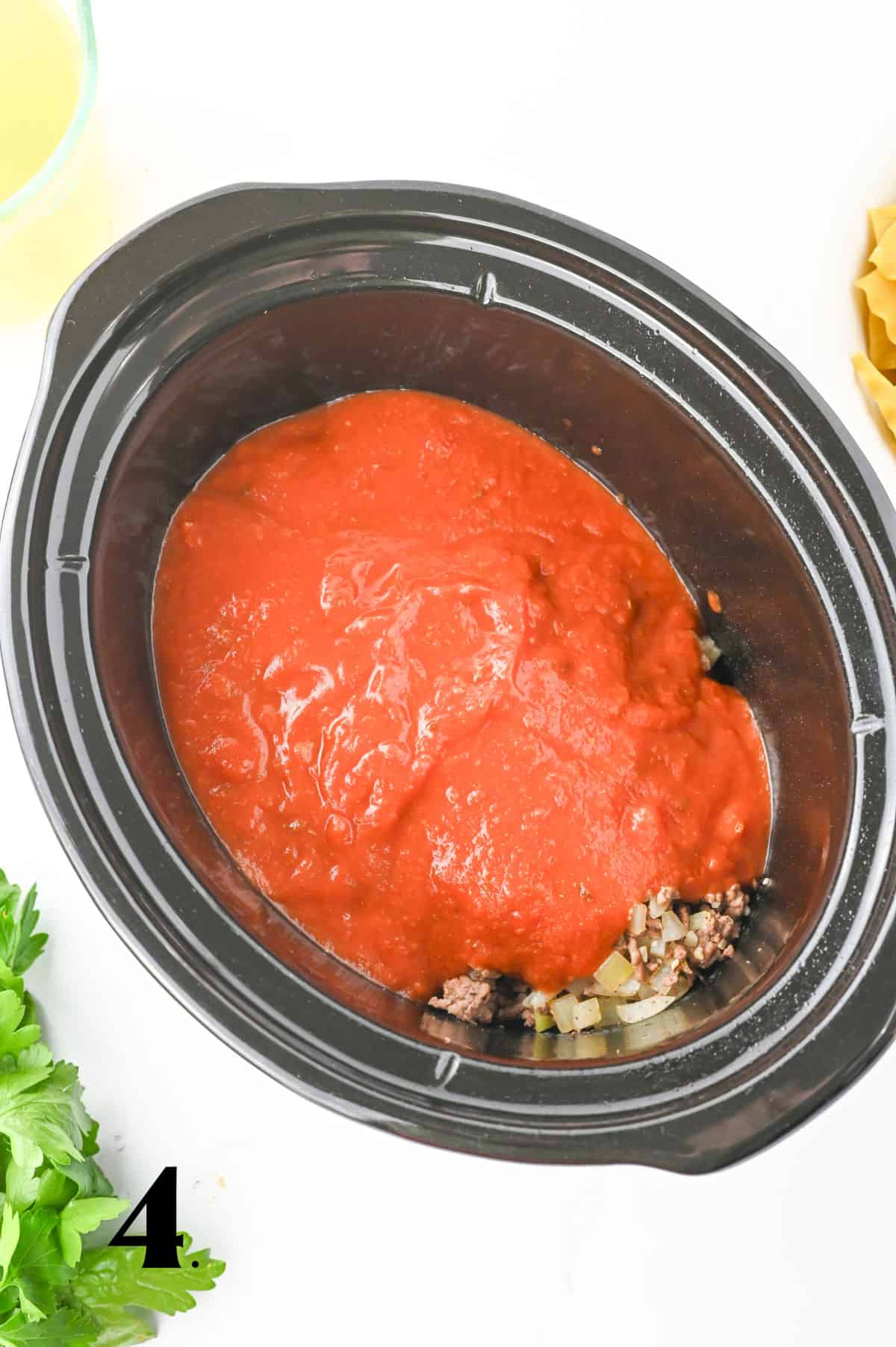 How to Make Crockpot Lasagna Soup Step 4 - adding sauce.