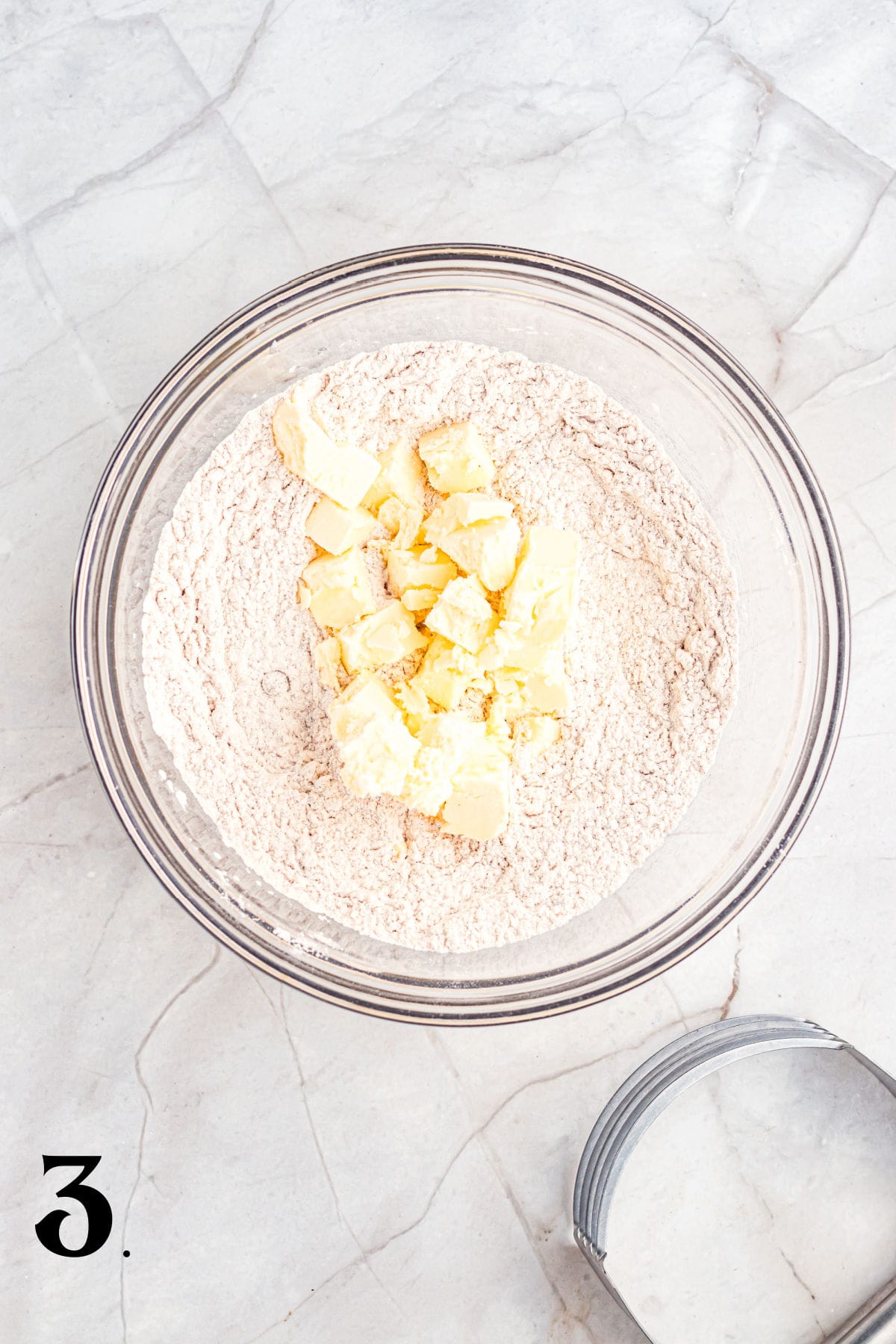How to Make Pecan Maple Scones - Step 3 adding butter pieces.