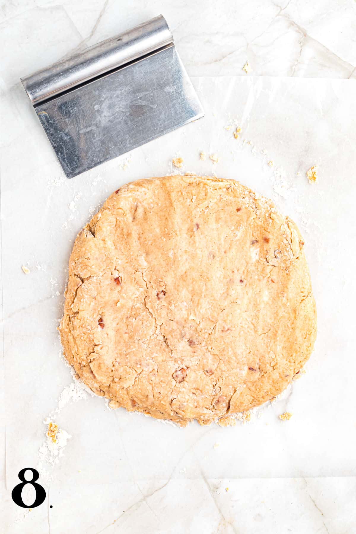 How to Make Pecan Maple Scones - Step 8 with dough in a flat circle.