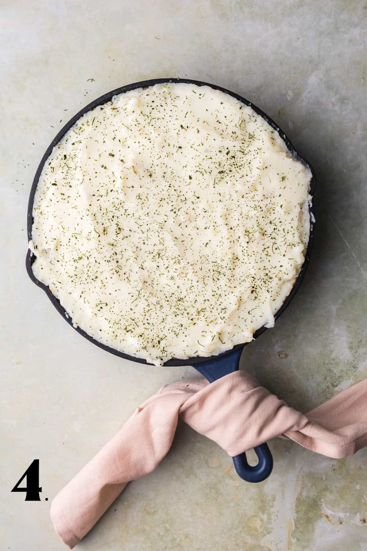 How to Make Shepherd's Pie - Step 4 with potatoes scooped on it.