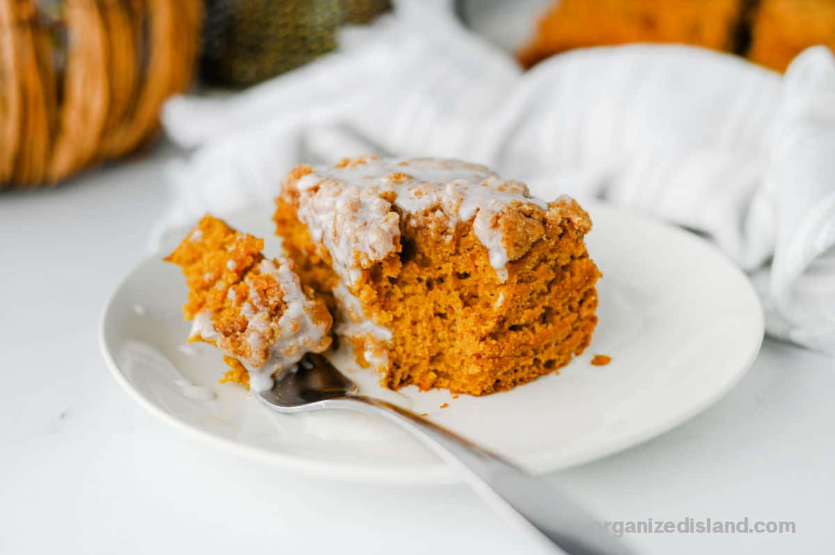 Pumpkin Coffee Cake with glaze on plate with fork.