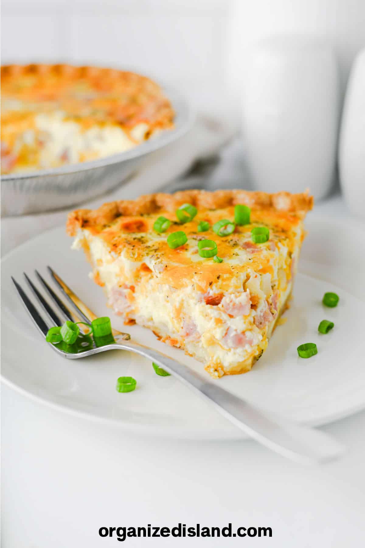 Ham and Cheese Quiche on plate with fork.