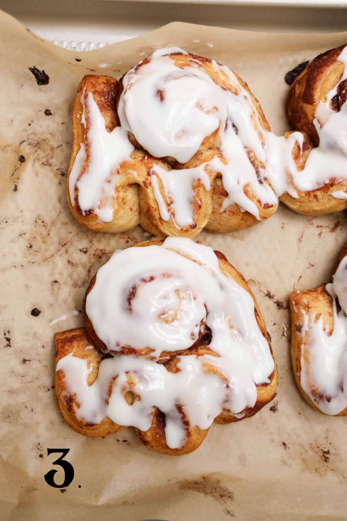 How to Make Cinnamon Roll Ghosts - Step 3 - frost with icing.